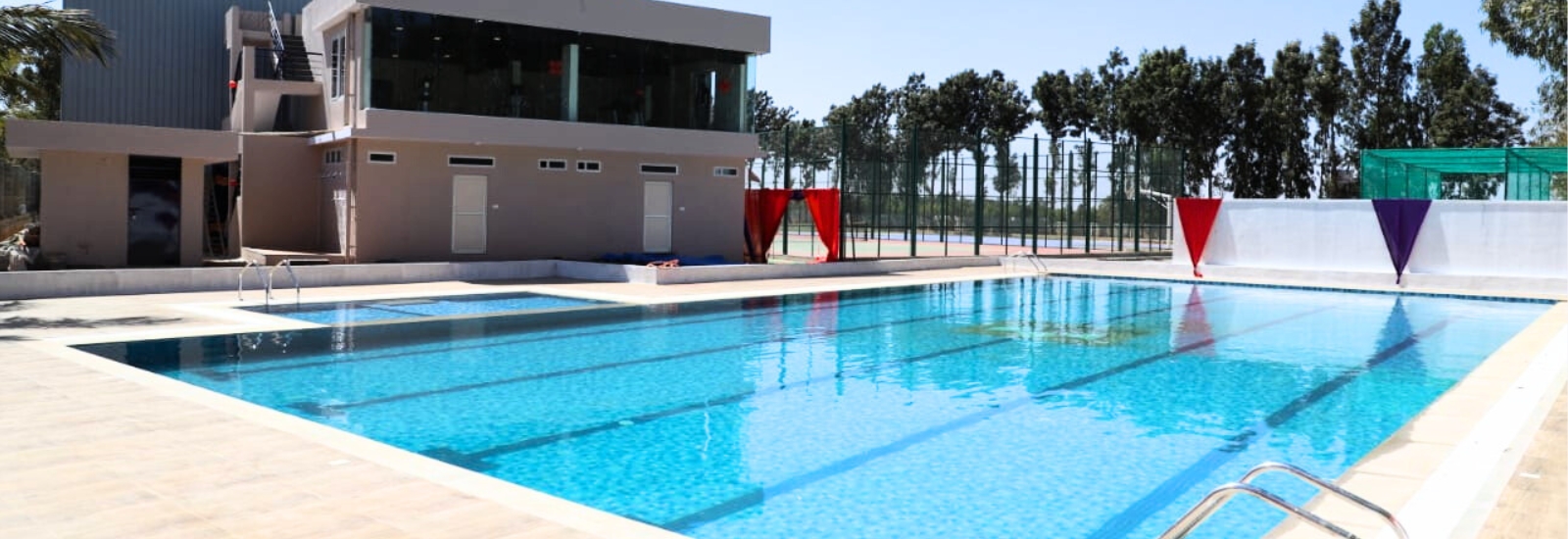 Swimming pool and sports facility at NewAge World School Yelahanka, showcasing modern amenities for student recreation and fitness.